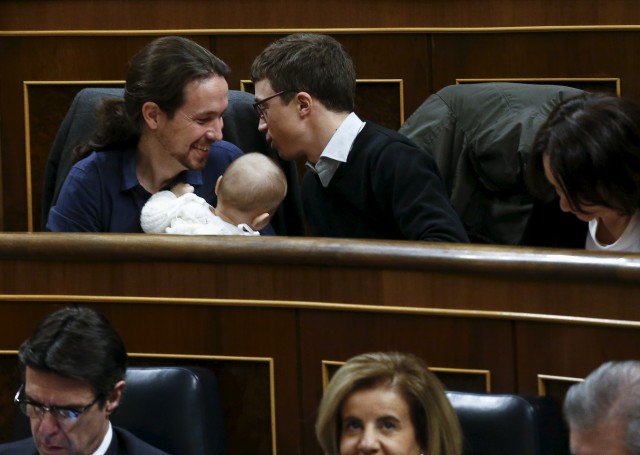 Podemos (We Can) party leader Iglesias and Podemos deputy Errejon admire the infant son of fellow party deputy Bescansa as parliament convened in Madrid