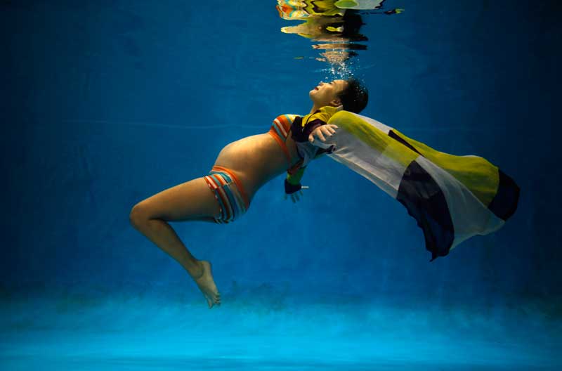 Jiejin Qiu, who is six months pregnant with her first baby, poses underwater during a photo shoot at a local wedding photo studio in Shanghai September 5, 2014. Reuters Photographer Carlos Barria photographed a person born in each year China?s one child policy has been in existence; from a man born in 1979, to a baby born in 2014, and asked them if they would have like to have siblings. China, the world's most populous country with nearly 1.4 billion people, says the country's one-child policy has averted 400 million births since 1980, saving scarce food resources and helping to pull families out of poverty. Couples violating the policy have had to pay a fine, or in some cases have been forced to undergo abortions.  But late last year, China said it would allow millions of families to have two children, part of a plan to raise fertility rates and ease the financial burden on a rapidly ageing population. Picture taken September 5, 2014. REUTERS/Carlos Barria  (CHINA - Tags: SOCIETY POLITICS PORTRAIT TPX IMAGES OF THE DAY) 

ATTENTION EDITORS - PICTURE 01 OF 37 FOR WIDER IMAGE STORY '36 YEARS CHINA'S ONE CHILD POLICY'
SEARCH 'BARRIA CHILD' FOR ALL PICTURES - RTR491X1