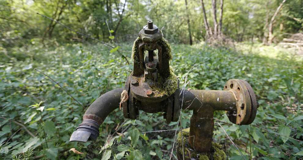 Rusted pipework is seen near an abandoned paraffin wax factory in a forest in Merkwiller-Pechelbronn, May 7, 2014. Alsace, the cradle of the French oil exploration industry in the mid-18th century, is witnessing a tentative return of small oil explorers in the eastern region on the German border. With oil prices hovering around $100, a dozen fields are pumping again, in a region that once provided 5 percent of French needs and gave birth to international oil services giants such as Schlumberger, before fading into insignificance in the 1960s when the barrel lingered around $15. Picture taken May 7, 2014.    REUTERS/Vincent Kessler     (FRANCE - Tags: BUSINESS COMMODITIES ENERGY)

ATTENTION EDITORS: PICTURE 09 OF 20 FOR WIDER IMAGE PACKAGE 'BLACK GOLD OF ALSACE' 
TO FIND ALL IMAGES SEARCH 'ALSACE KESSLER' - RTR48GWN