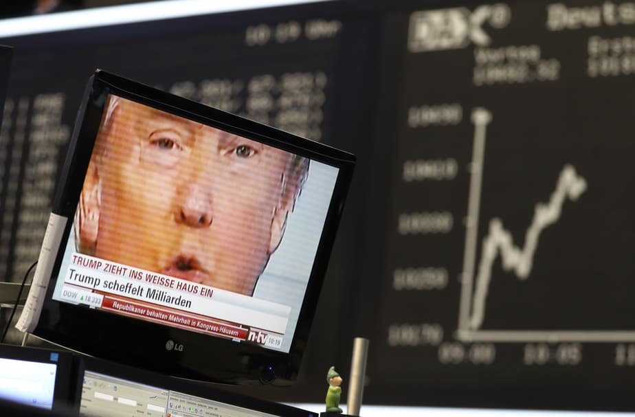 A TV screen showing U.S. President-elect Donald Trump is pictured in front of the German share price index, DAX board, at the stock exchange in Frankfurt, Germany, November 9, 2016. REUTERS/Staff/Remote - RTX2SQVH
