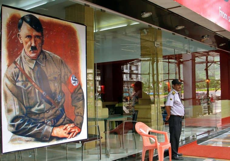 A security personnel stands guard outside a new restaurant, named after Adolf Hitler and promoted with posters showing the German leader and Nazi swastikas, on the outskirts of Mumbai August 21, 2006. The new restaurant in India's financial hub has infuriated the country's small Jewish community. REUTERS/Stringer (INDIA) - RTR1GKID