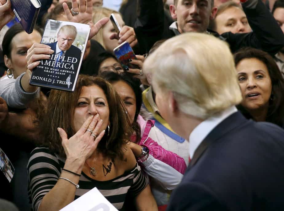 A woman blows a kiss to Republican presidential candidate Donald Trump (R) after Trump autographed her chest at his campaign rally in Manassas, Virginia December 2, 2015.  Republican presidential front-runner Trump said on Wednesday his plan for combating Islamic State militants involves targeting not just the group's fighters but also their families.         REUTERS/Gary Cameron     - RTX1WXD4