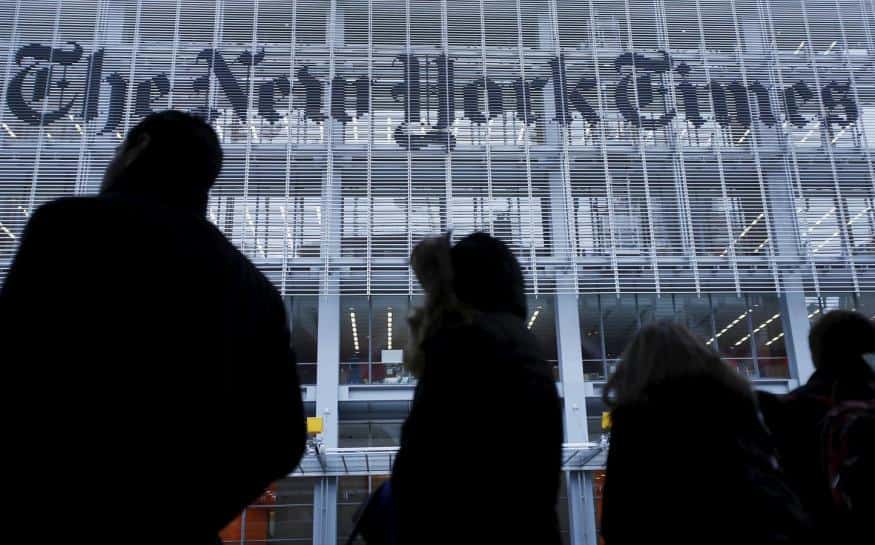 People stand across the street from the New York Times head office in New York, in this February 7, 2013, file photo.   REUTERS/Carlo Allegri/Files