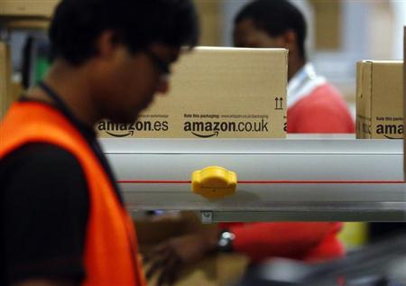 A worker packs boxes at Amazon's logistics centre in Graben near Augsburg December 17, 2012. REUTERS/Michael Dalder
