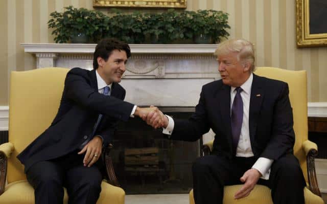 Canadian Prime Minister Justin Trudeau (L) shakes hands with U.S. President Donald Trump in the Oval Office at the White House in Washington, U.S., February 13, 2017.  REUTERS/Kevin Lamarque