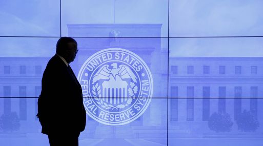 A security guard walks in front of an image of the Federal Reserve following the two-day Federal Open Market Committee (FOMC) policy meeting in Washington, March 16, 2016.  REUTERS/Kevin Lamarque/File Photo