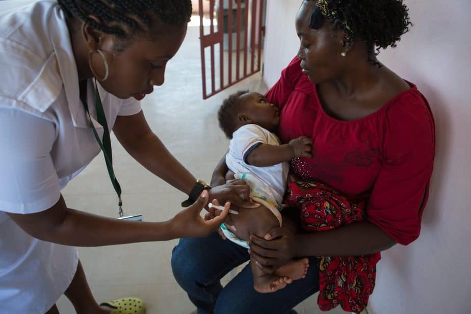 A young girl receives a vaccine injection during vaccinations at Mahulana Health Center, Moamba District, Maputo Province, Mozambique (2017).