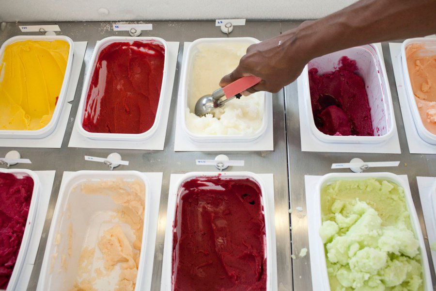 Christina Briscoe scoops ice cream at Il Laboratorio del Gelato, an ice cream shop in New York, July 15, 2012. The third Sunday of every July is National Ice Cream Day in the United States.   REUTERS/Andrew Burton (UNITED STATES - Tags: FOOD SOCIETY) - RTR34YWC