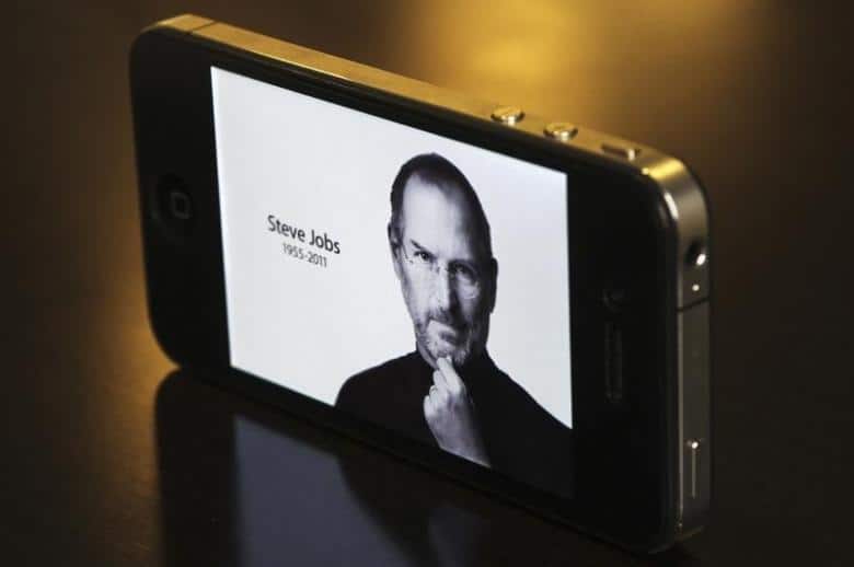The main Apple Inc website featuring Apple co-founder Steve Jobs is seen on an iPhone in this photo illustration taken in Central Sydney October 6, 2011. REUTERS/Daniel Munoz