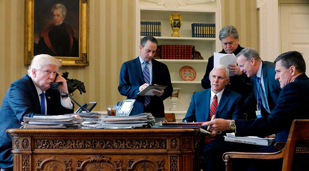 De izquierda a derecha) por el Jefe de Gabinete Reince Priebus, el Vicepresidente Mike Pence, el asesor principal Steve Bannon, el Director de Comunicaciones Sean Spicer y el Asesor de Seguridad Nacional Michael Flynn, en la Oficina Oval. (Reuters / Jonathan Ernst)