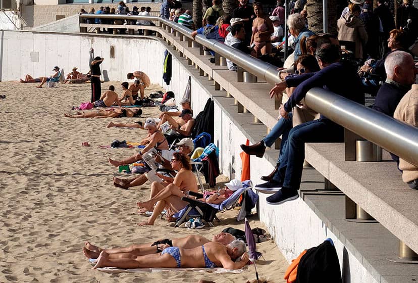 People sunbath at the beach during a long weekend in Benidorm, Spain, December 9, 2017. REUTERS/Heino Kalis  TEMPLATE OUT